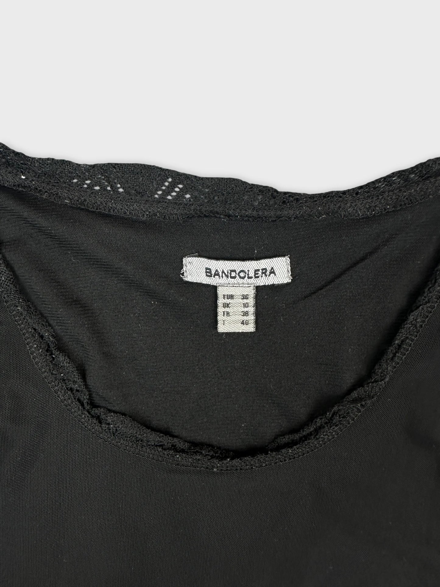 Detail view of a black women body shirt with lace trim.
