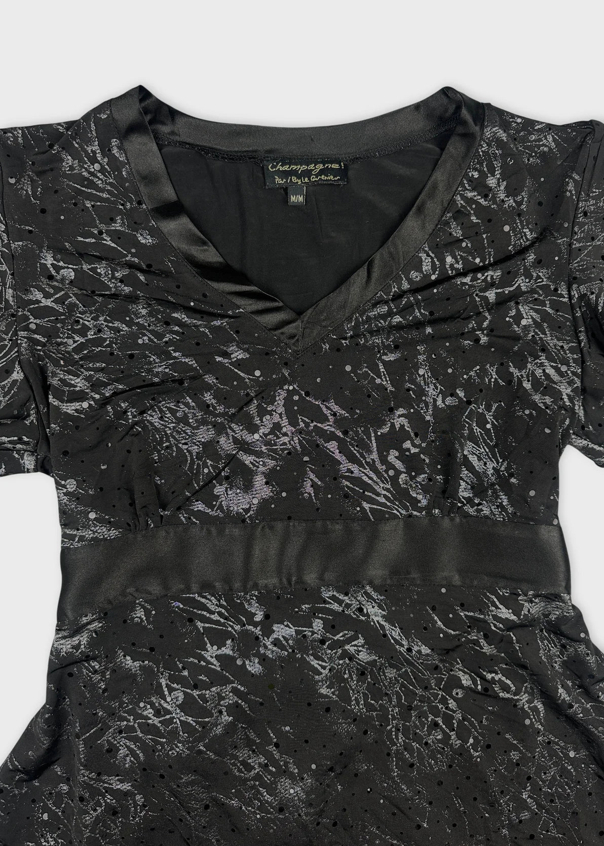 Detail view of a black body shirt with metallic floral print.