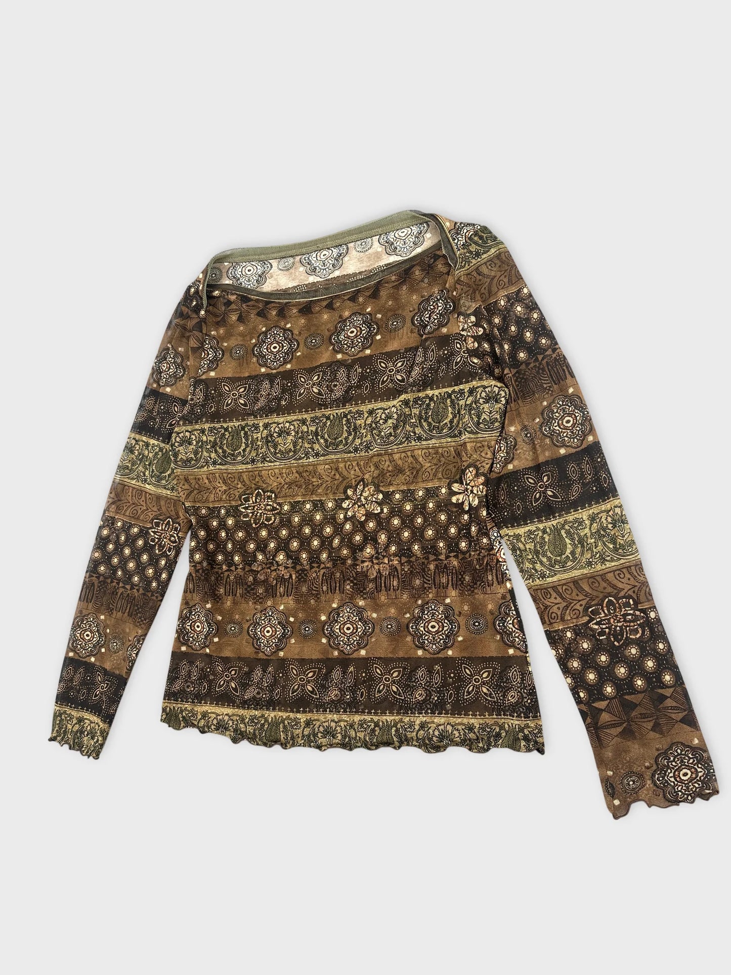 Detail view of a brown patterned women body shirt with scalloped hem.