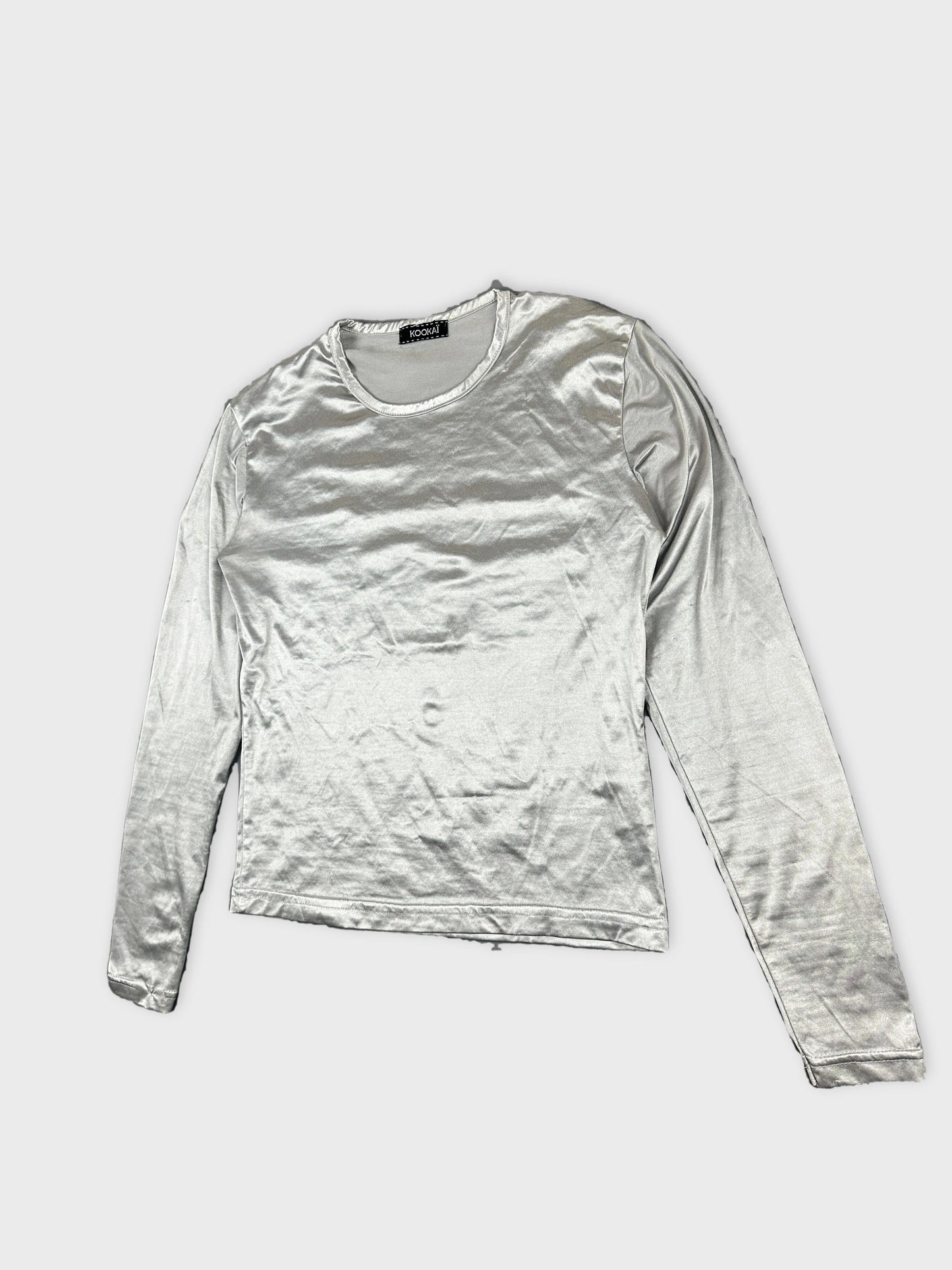 Detail view of a long-sleeve silver body shirt with a smooth texture.