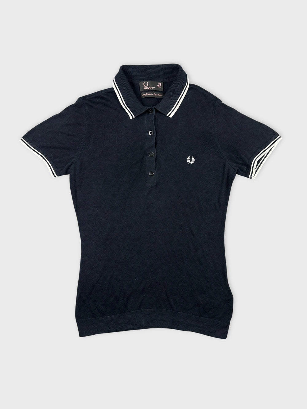 Front view of a navy polo shirt with white collar trim and logo