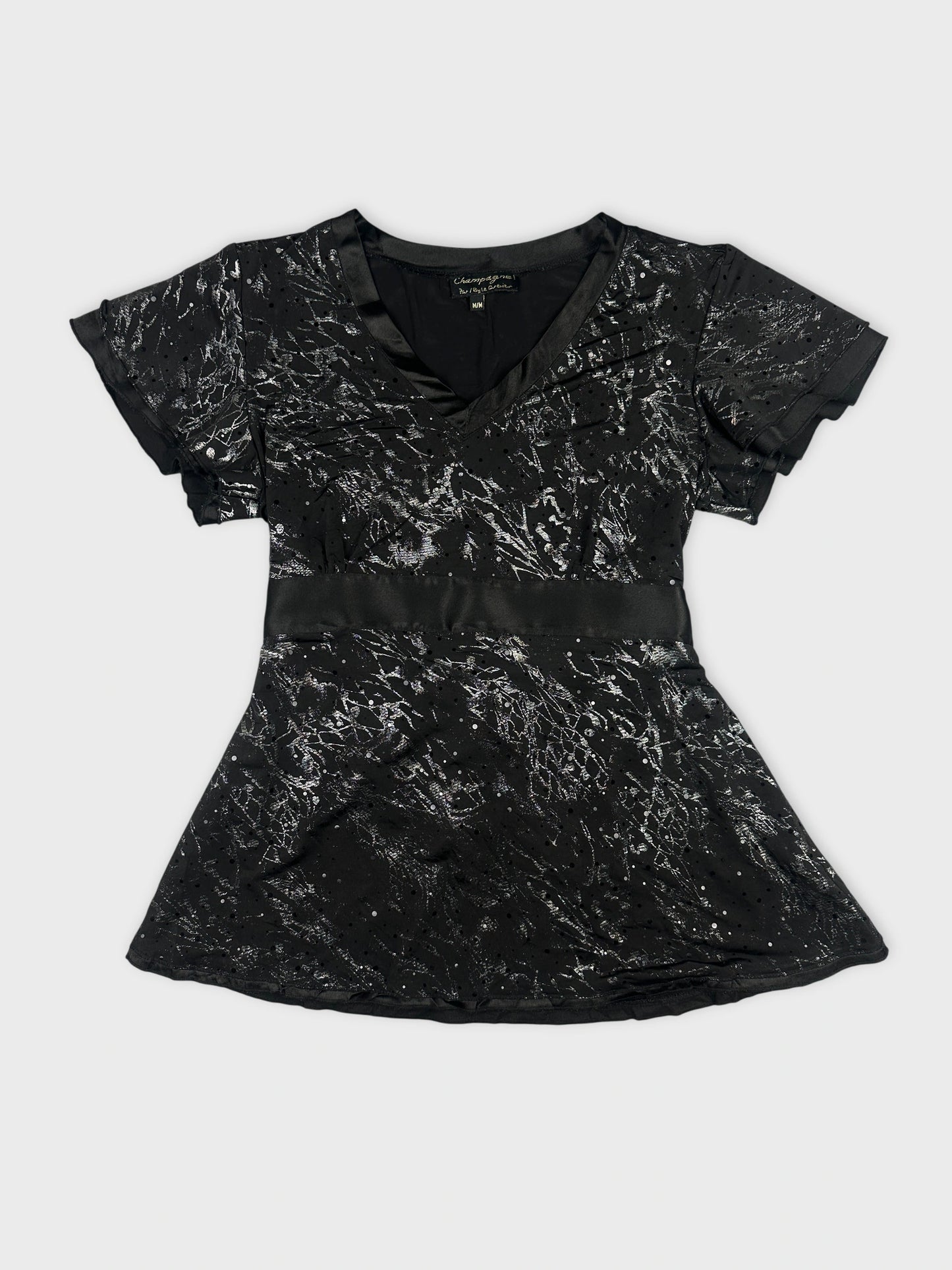 Front view of a black women’s body shirt with metallic pattern.