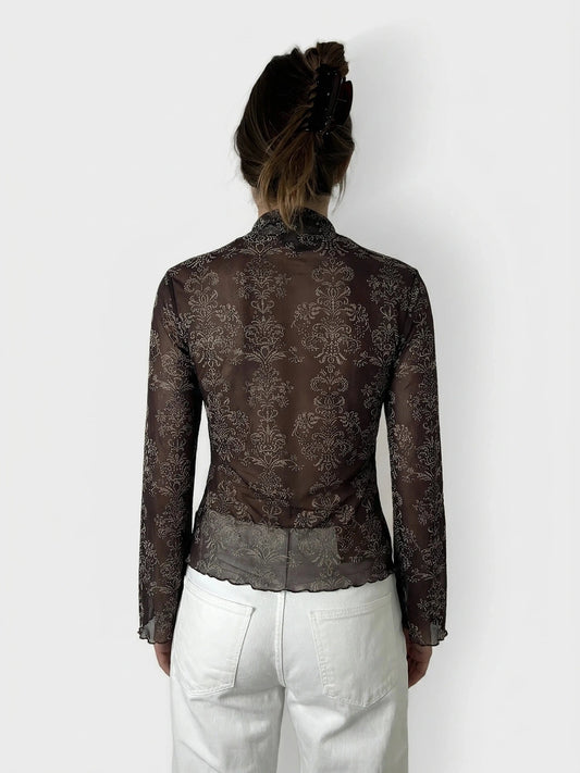 Back view of a brown body shirt featuring a floral pattern.