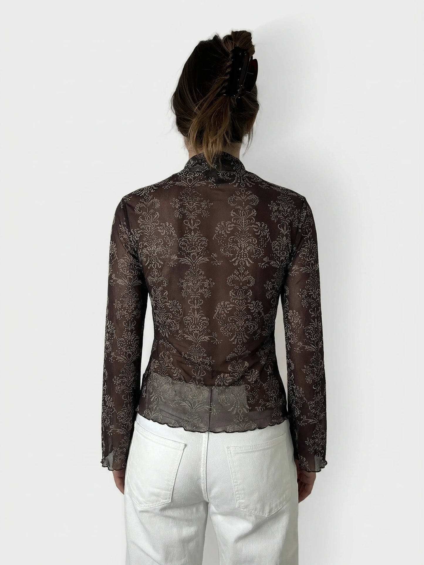 Back view of a brown body shirt featuring a floral pattern.