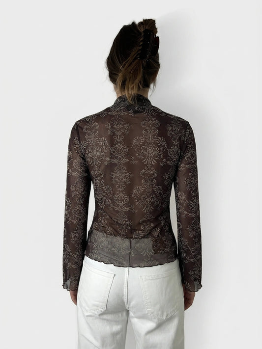 Back view of a brown body shirt featuring a floral pattern.