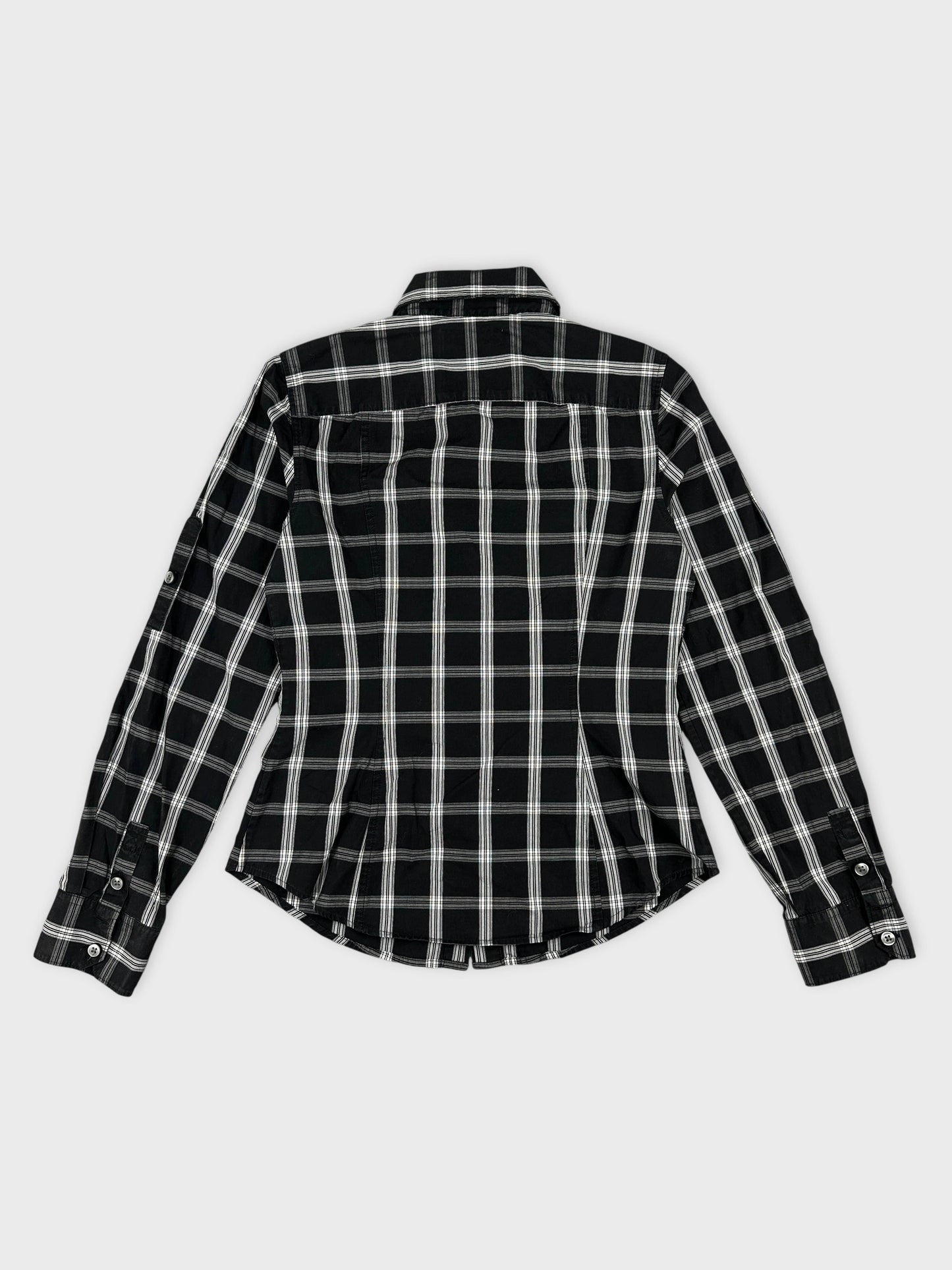 Back view of a black and white plaid T-shirt with buttoned sleeves.