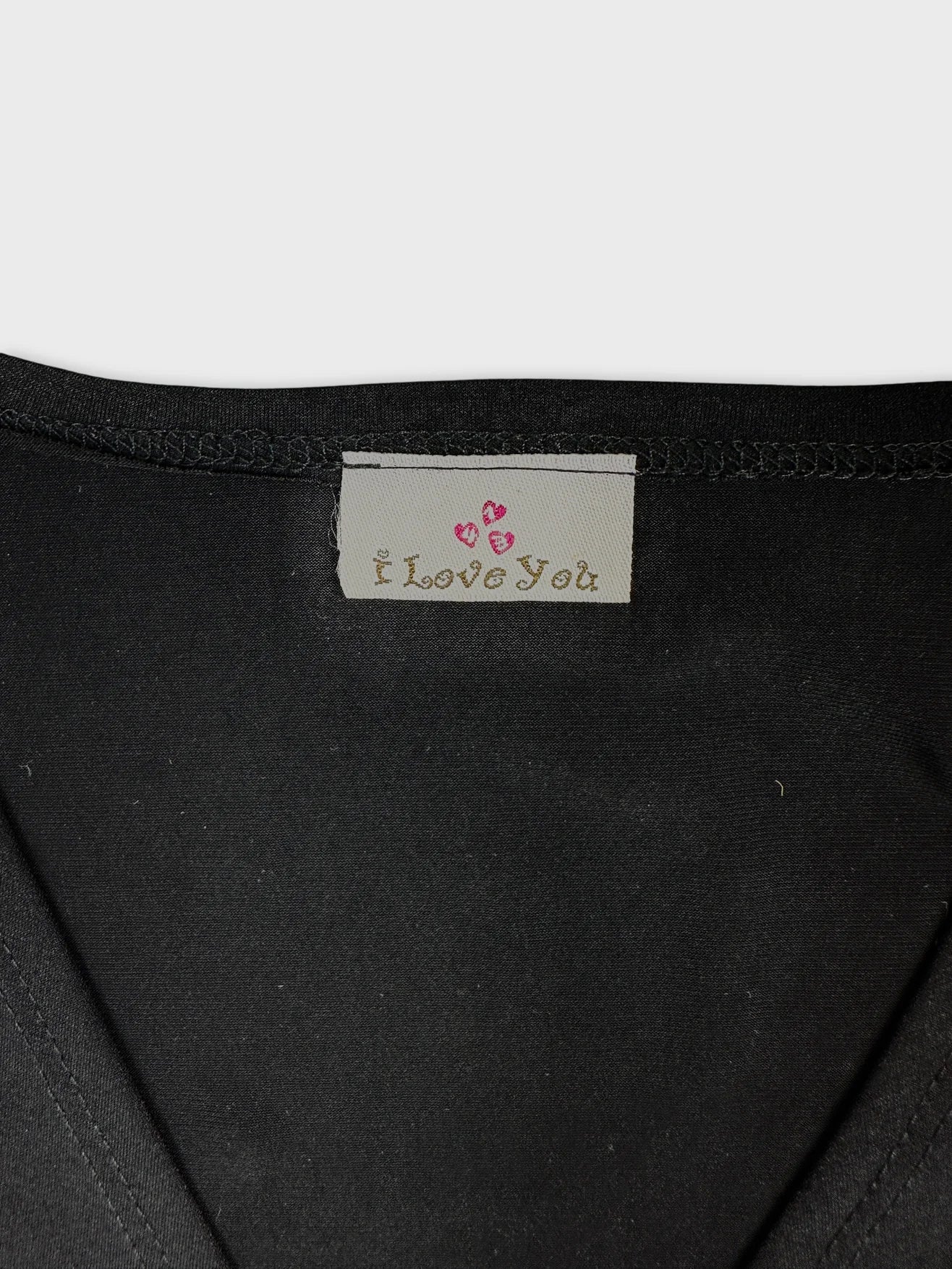 Detail view of a black body t-shirt showing the 'I Love You' label.