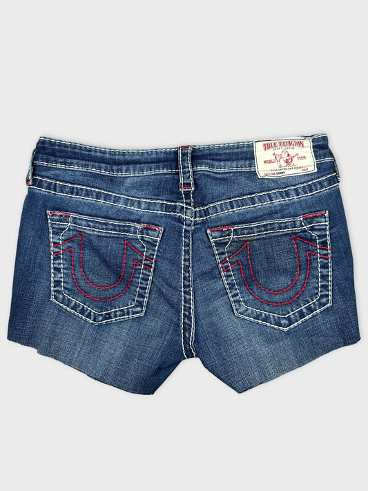 Back view of denim mini shorts featuring red embroidered pockets.