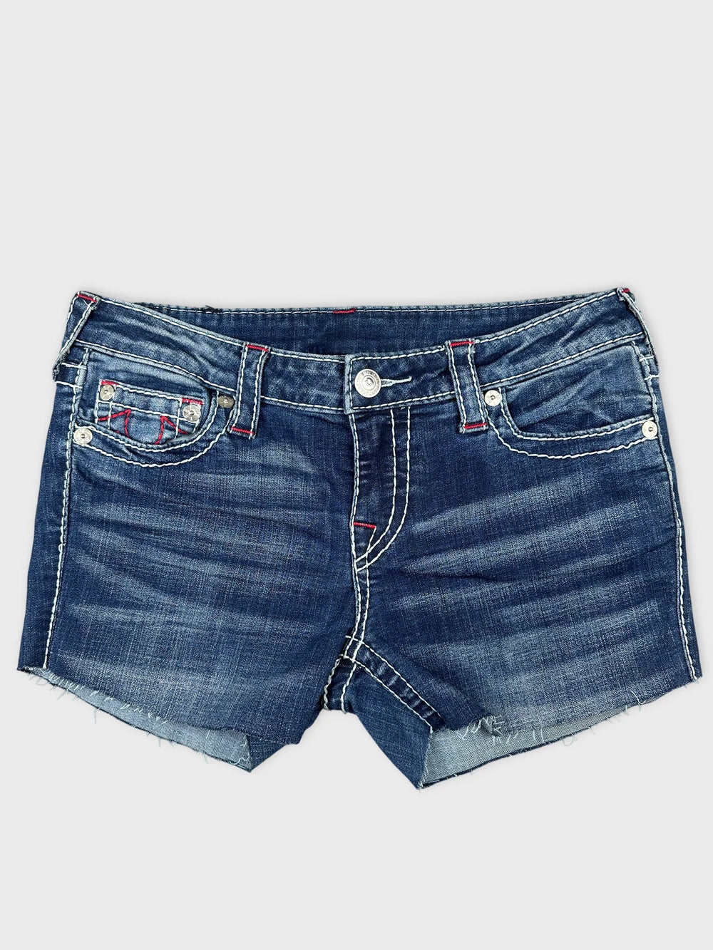 Front view of denim mini shorts in dark blue with frayed hems.