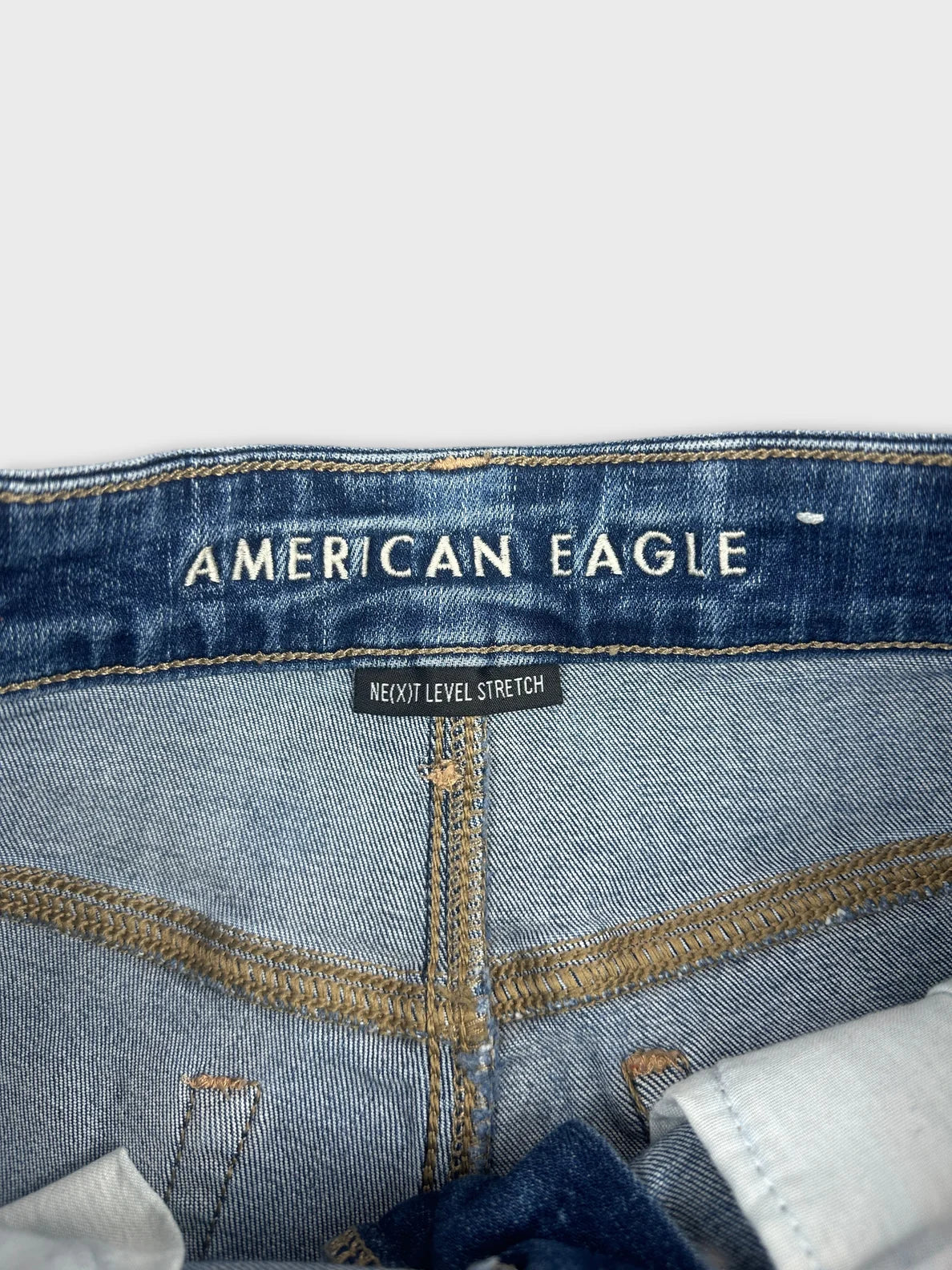 Detail view of women's denim shorts in blue with stretch label.
