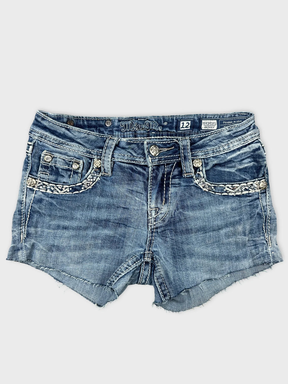 Front view of denim shorts featuring a braided trim and light blue color.