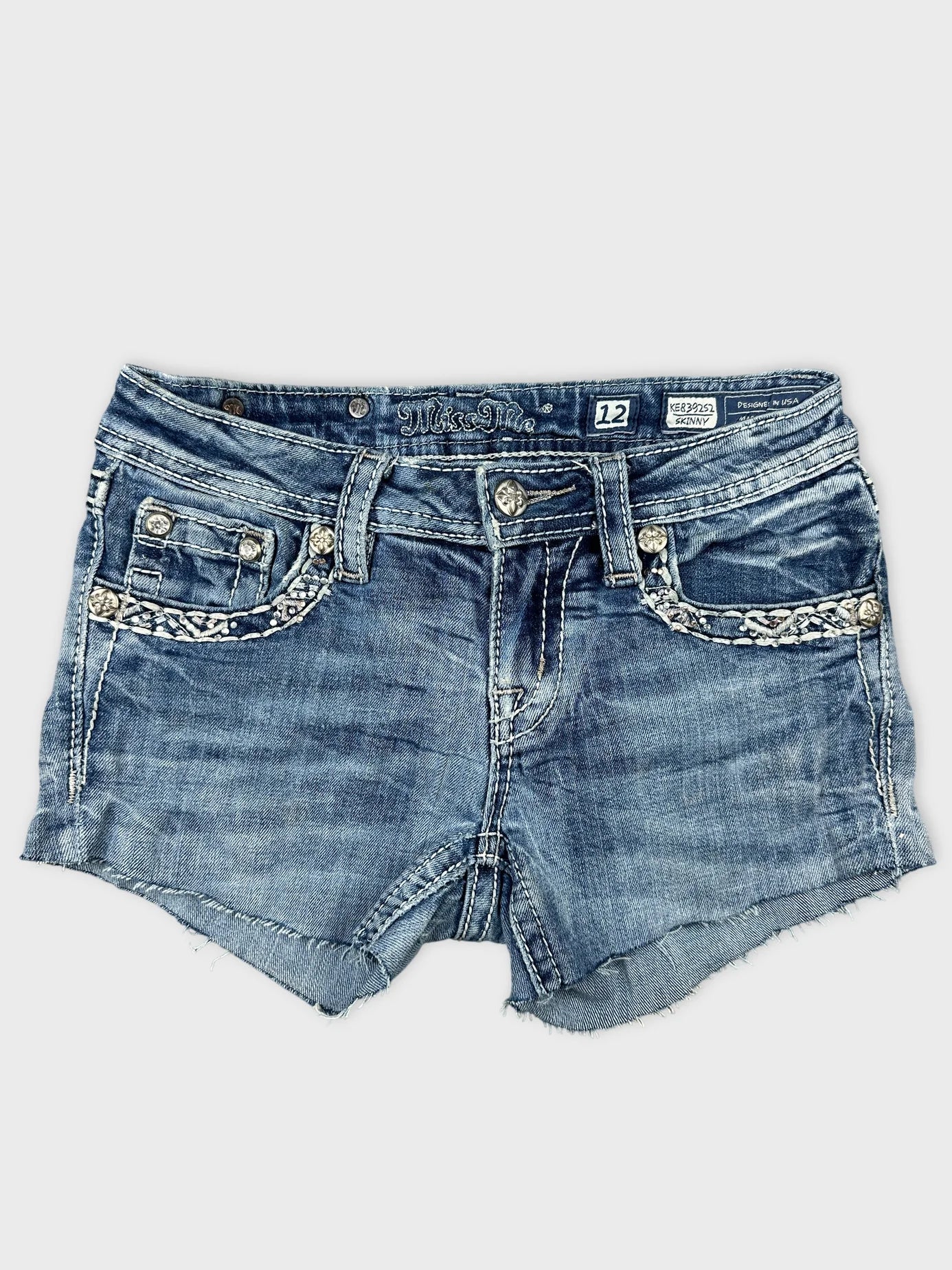 Front view of denim shorts featuring a braided trim and light blue color.