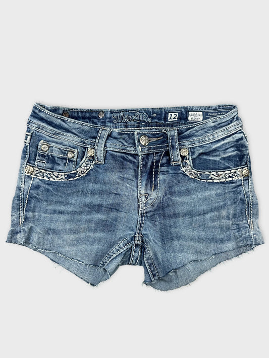 Front view of denim shorts featuring a braided trim and light blue color.