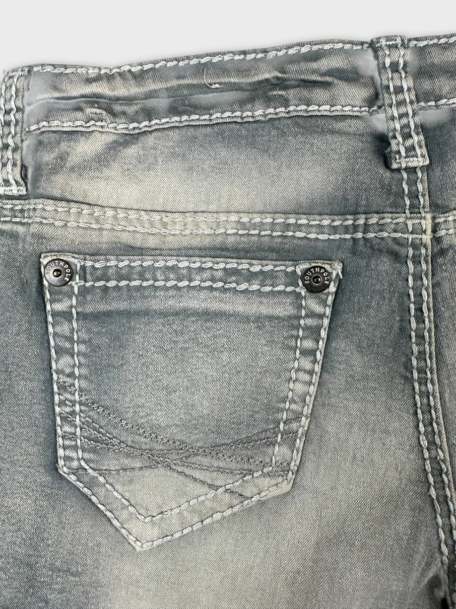 Detail view of gray women’s denim shorts with stitched pocket design.