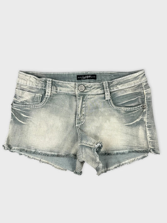 Front view of grey denim shorts featuring distressed hem and classic pockets.