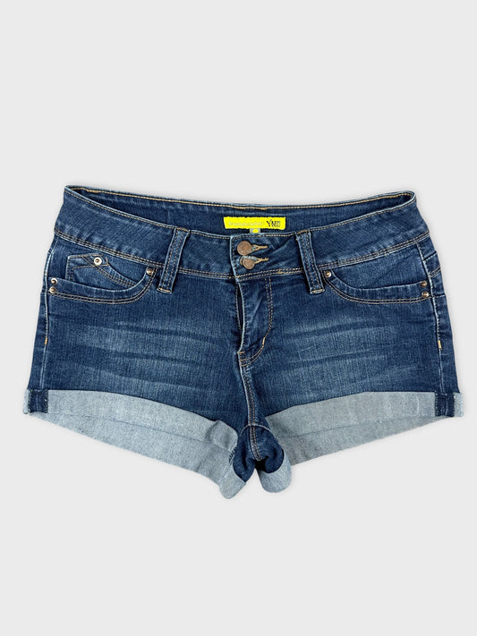 Front view of blue denim mini shorts with cuffed hems and dual buttons.