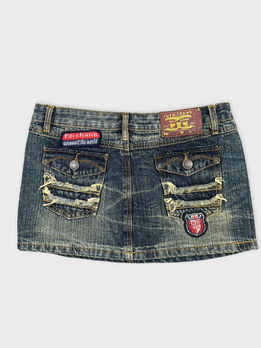 Back view of a denim mini skirt featuring distressed pockets and embroidery.
