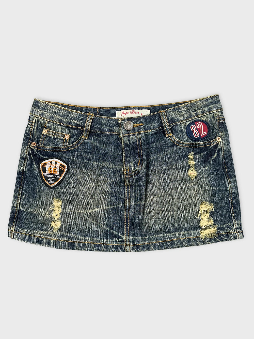 Front view of a mini denim skirt featuring patches and distressed details.