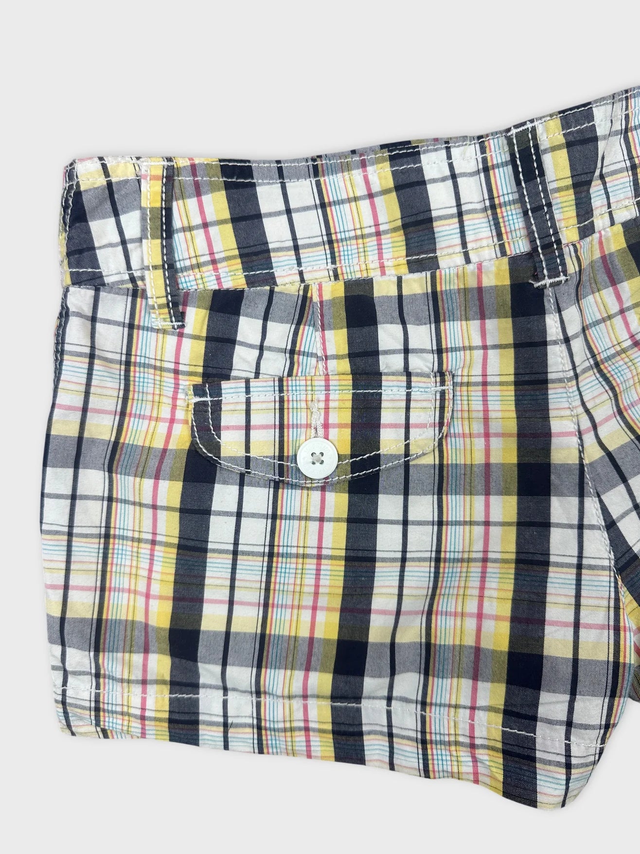 Detail view of women's shorts in colorful plaid pattern