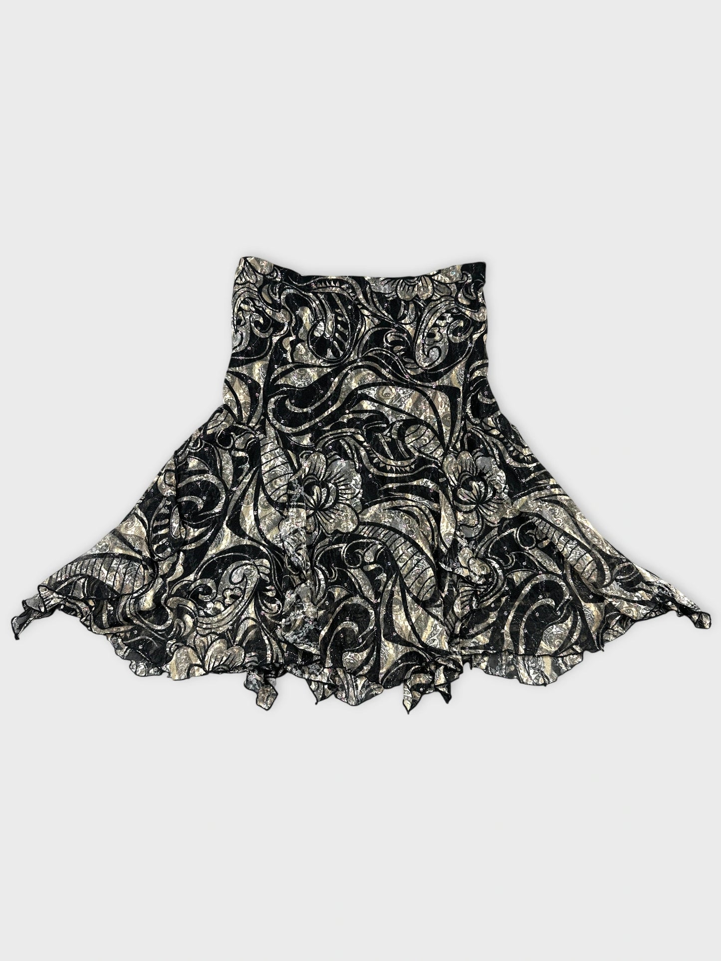 Back view of a black vintage skirt with floral pattern and ruffled hem.