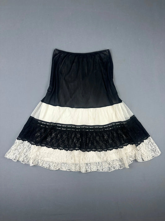 Back view of a black and white layered skirt with lace trim.