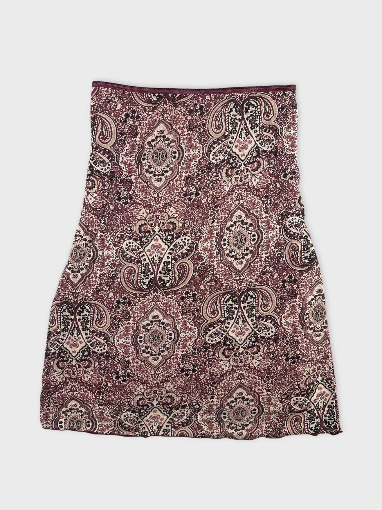 Back view of a burgundy printed skirt featuring an intricate paisley pattern.