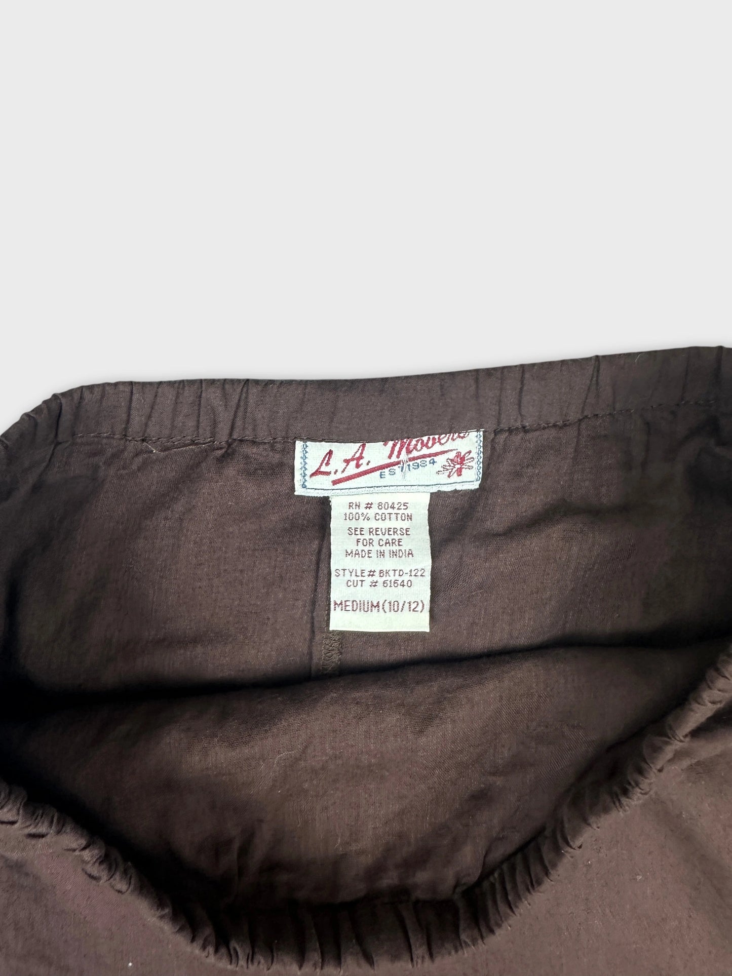 Detail view of brown vintage skirt with gathered waistband.