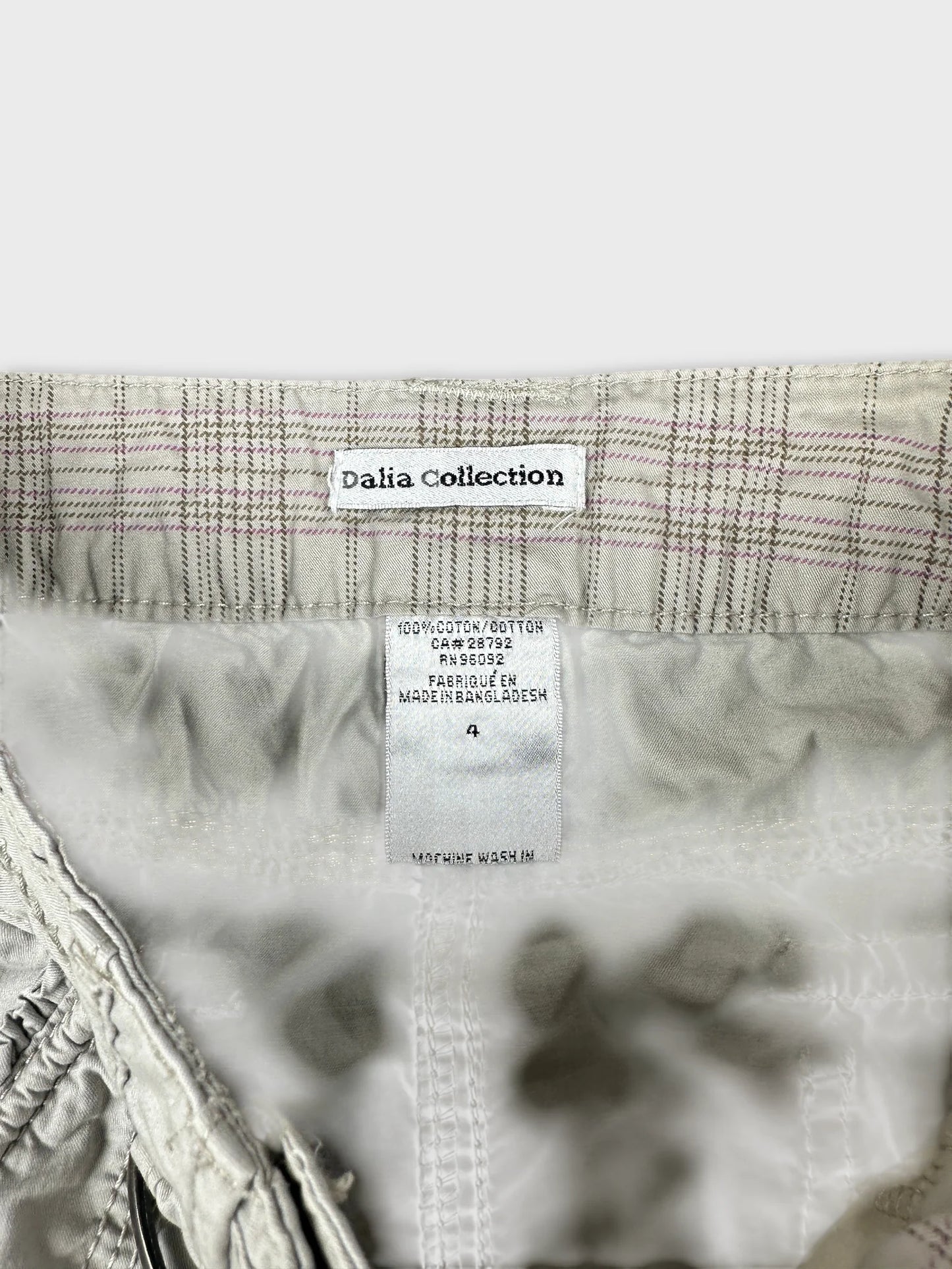 detail view of a light gray women's skirt with checked pattern