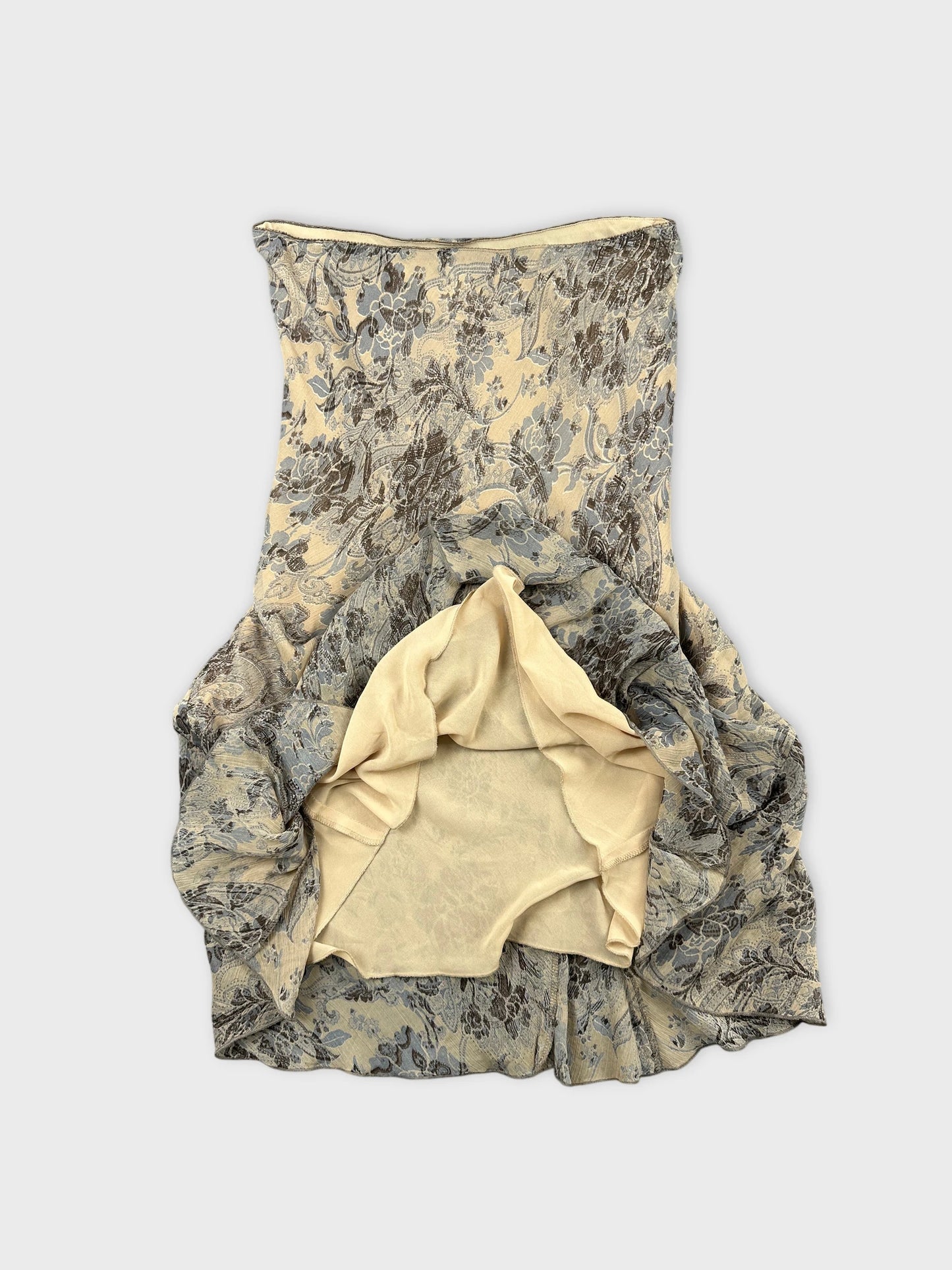 Detail view of a floral patterned vintage skirt in cream and blue.