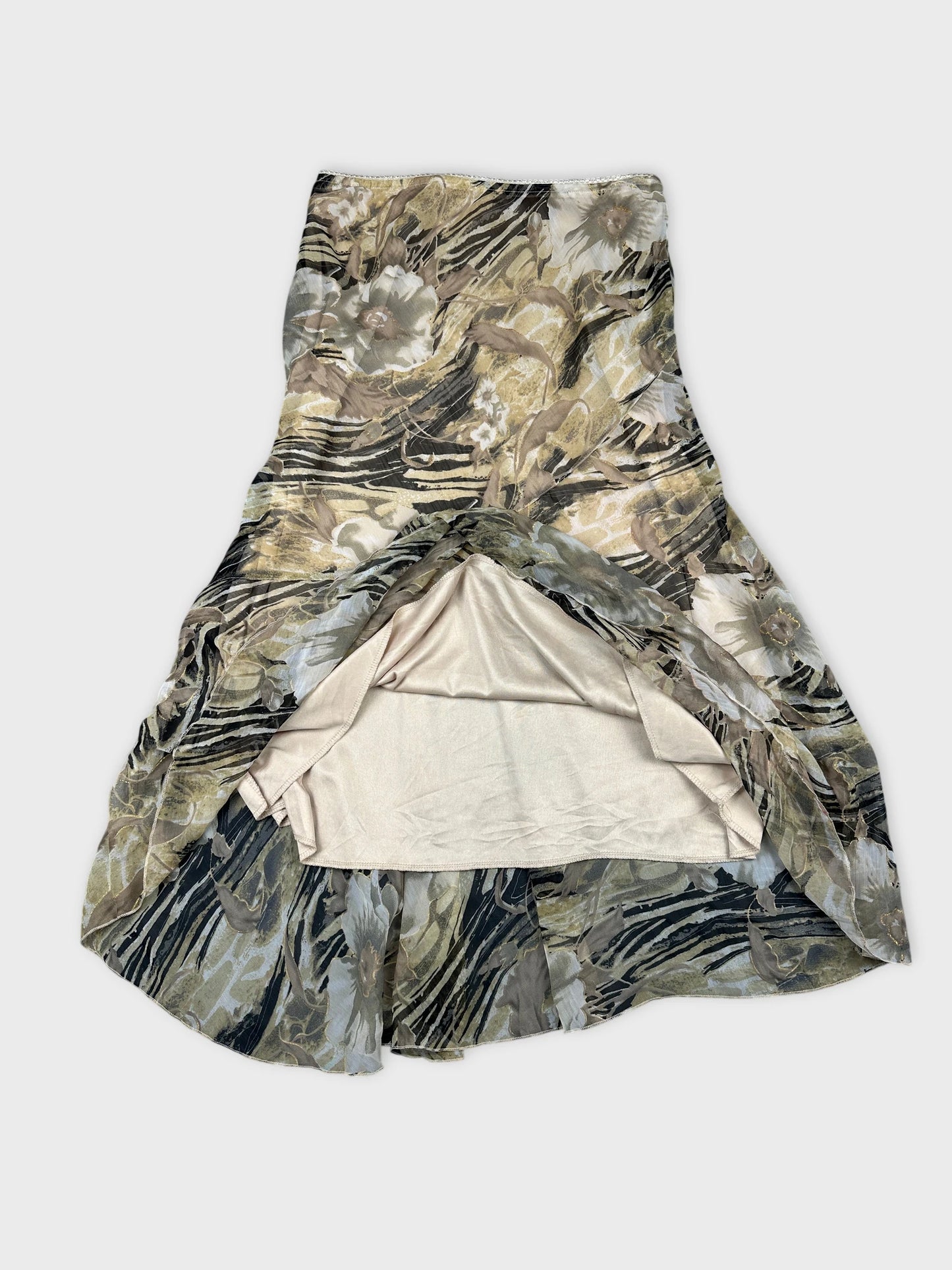 Detail view of a floral skirt in earthy tones with a ruffled hem.