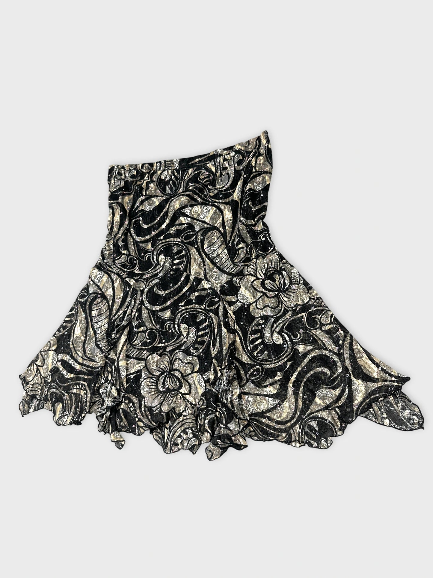Detail view of a black vintage skirt with floral silver pattern.