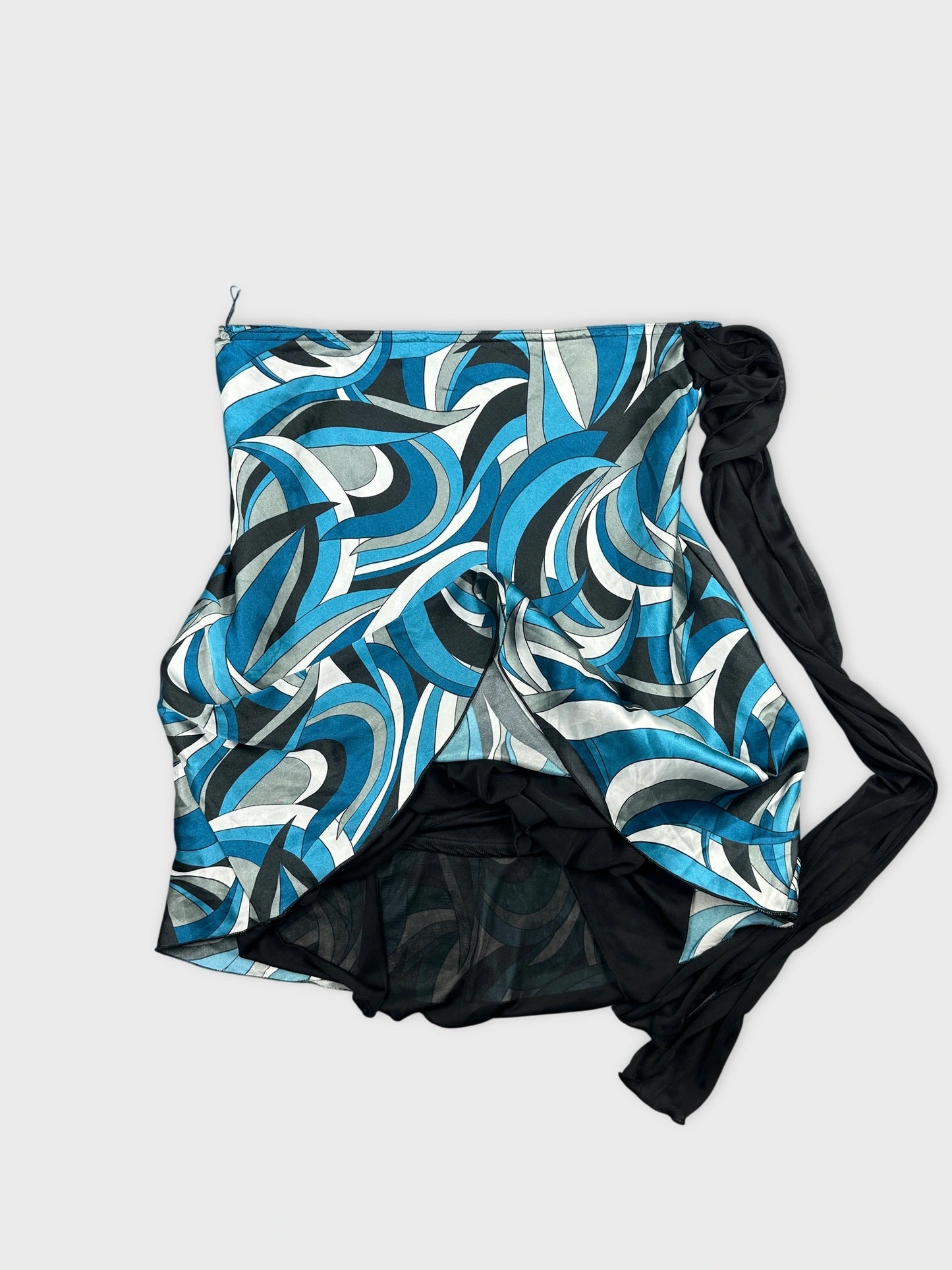 Detail view of a women's vintage skirt in blue swirling print with black trim.