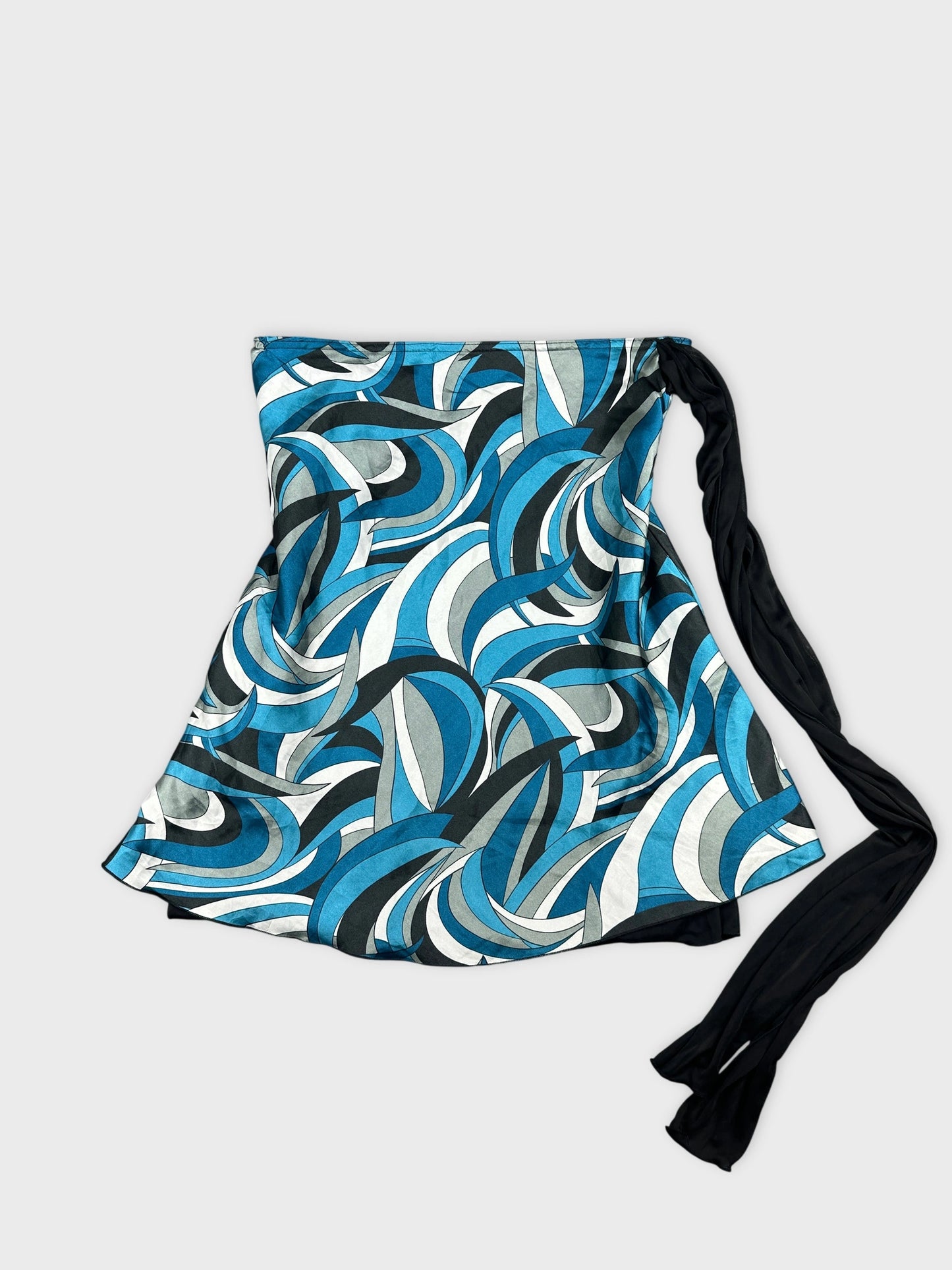 Front view of a blue patterned skirt featuring wave-like designs and a black tie.