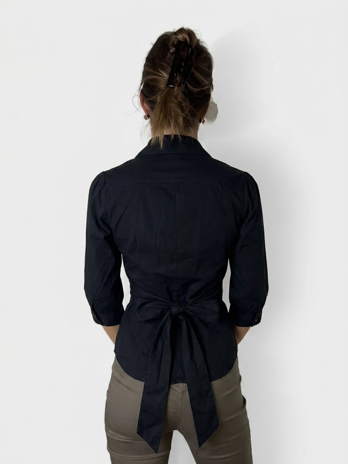Back view of a dark navy vintage shirt with a bow detail.