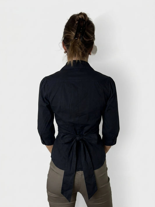 Back view of a dark navy vintage shirt with a bow detail.