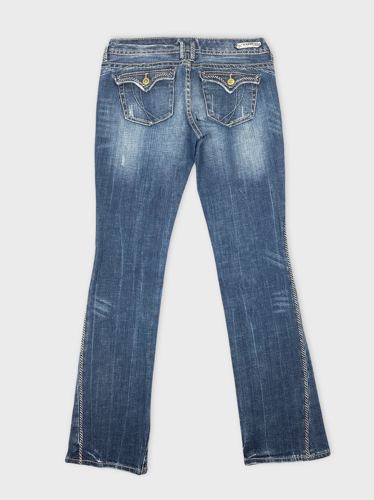 Back view of blue denim jeans featuring two back pockets with decorative stitching.