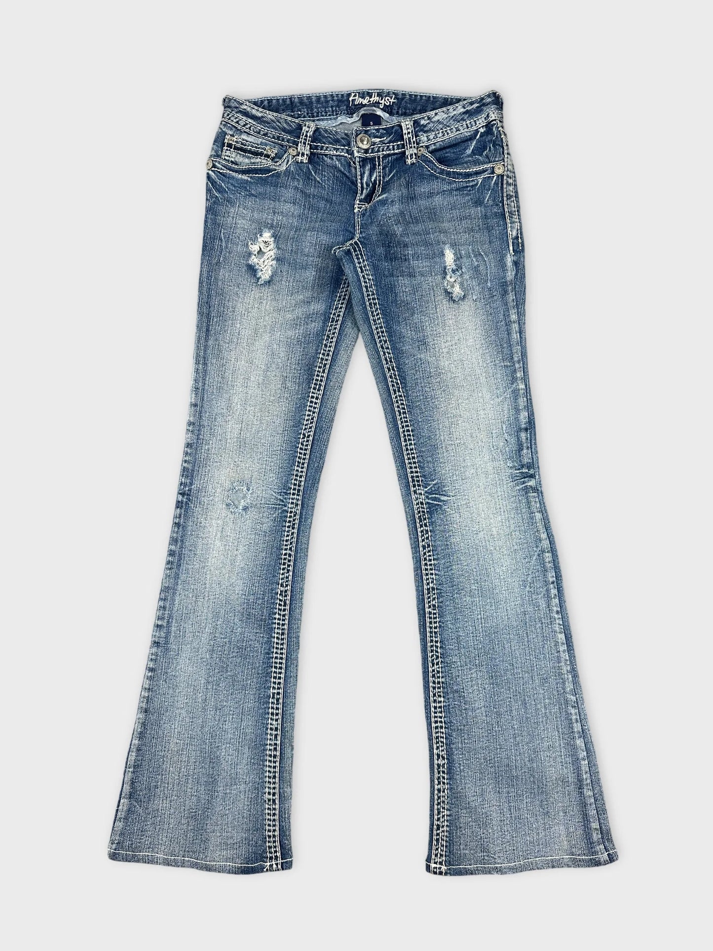 Front view of women denim jeans in light blue with distressed details.