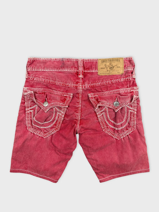 Back view of red denim shorts featuring embroidered pocket details.