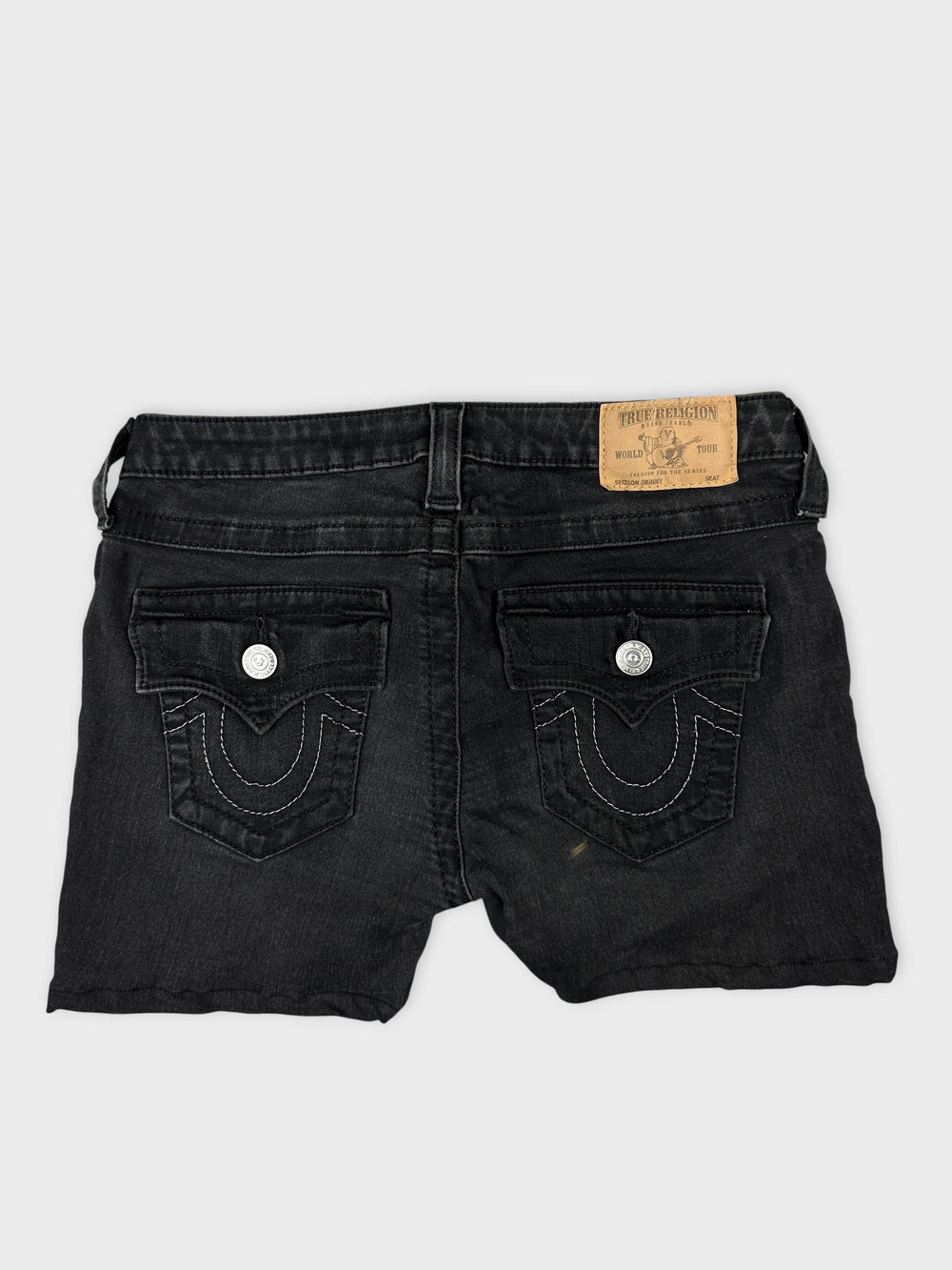 Back view of black denim shorts featuring detailed back pockets.