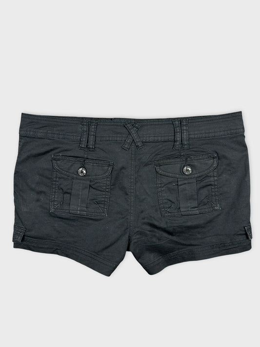 Back view of black denim shorts featuring two back pockets.