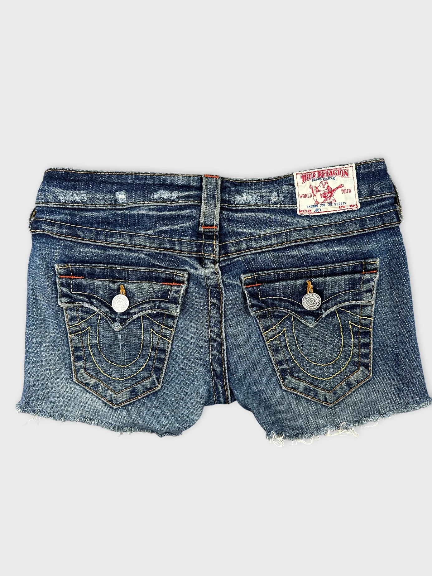 Back view of women denim shorts with embroidered pockets and frayed hem.