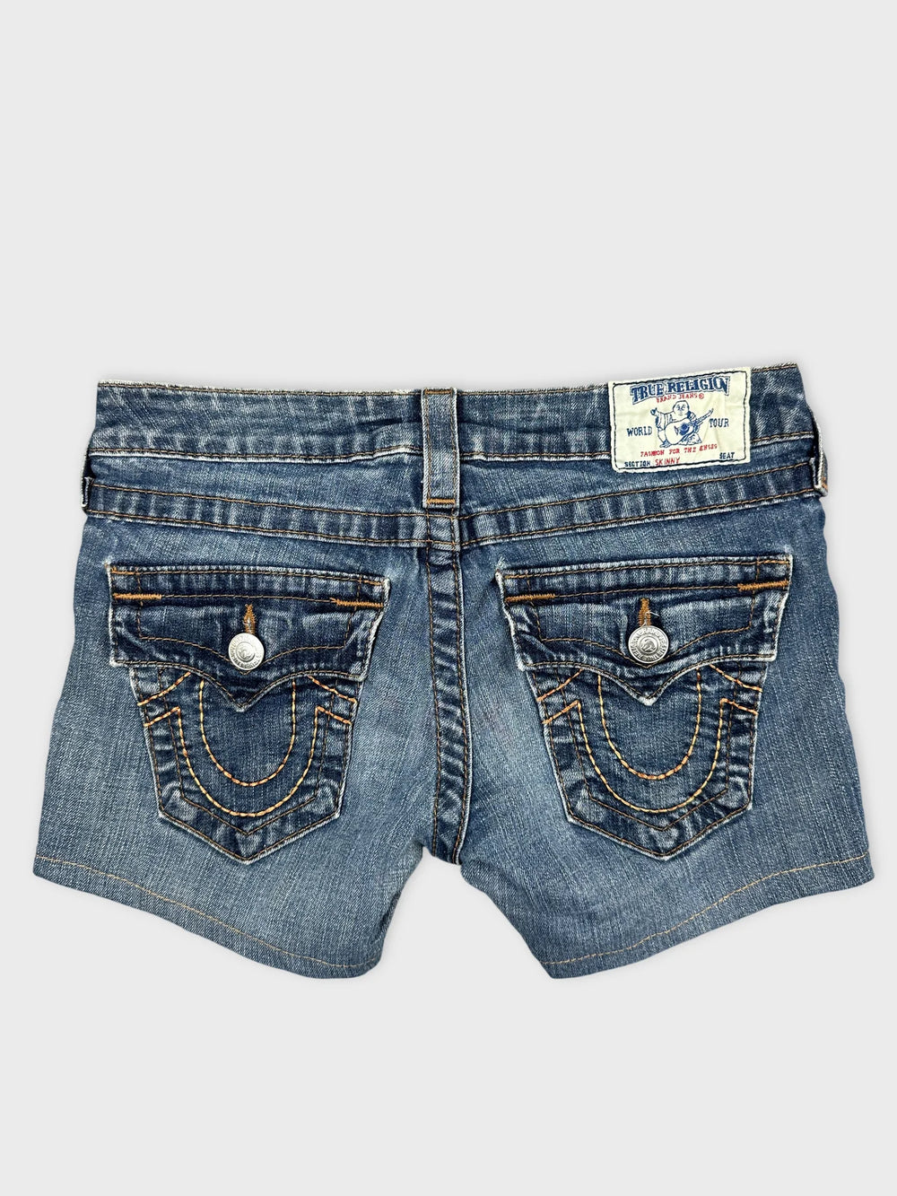 Back view of women's denim shorts featuring light blue fabric and unique pocket stitching.