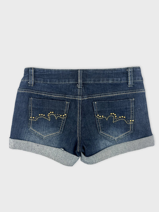 Back view of dark denim shorts featuring decorative gold studs on pockets.
