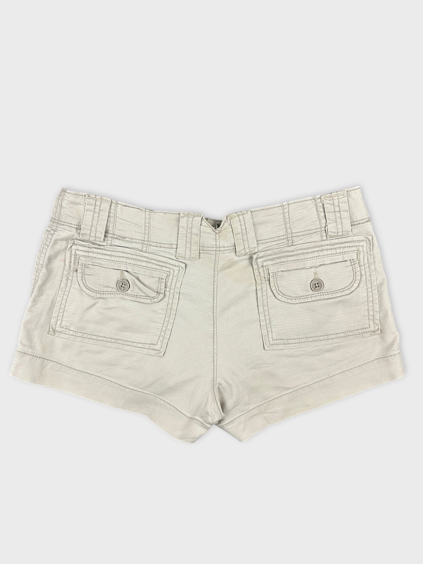 Back view of women denim shorts in light beige with two back pockets.