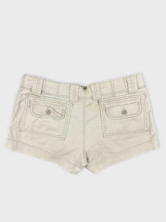 Back view of women denim shorts in light beige with two back pockets.