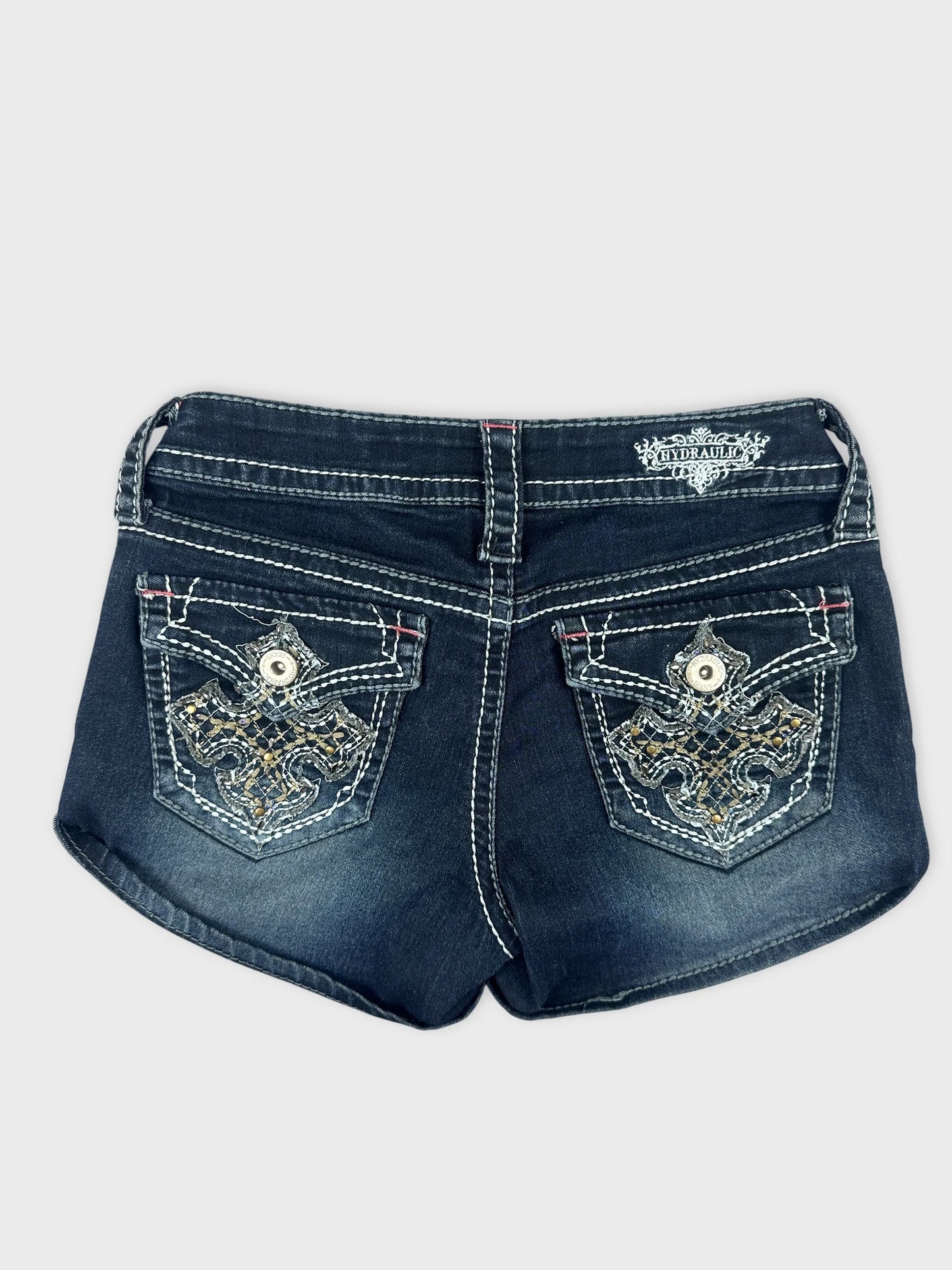 Back view of denim shorts in dark wash with embroidered pocket details