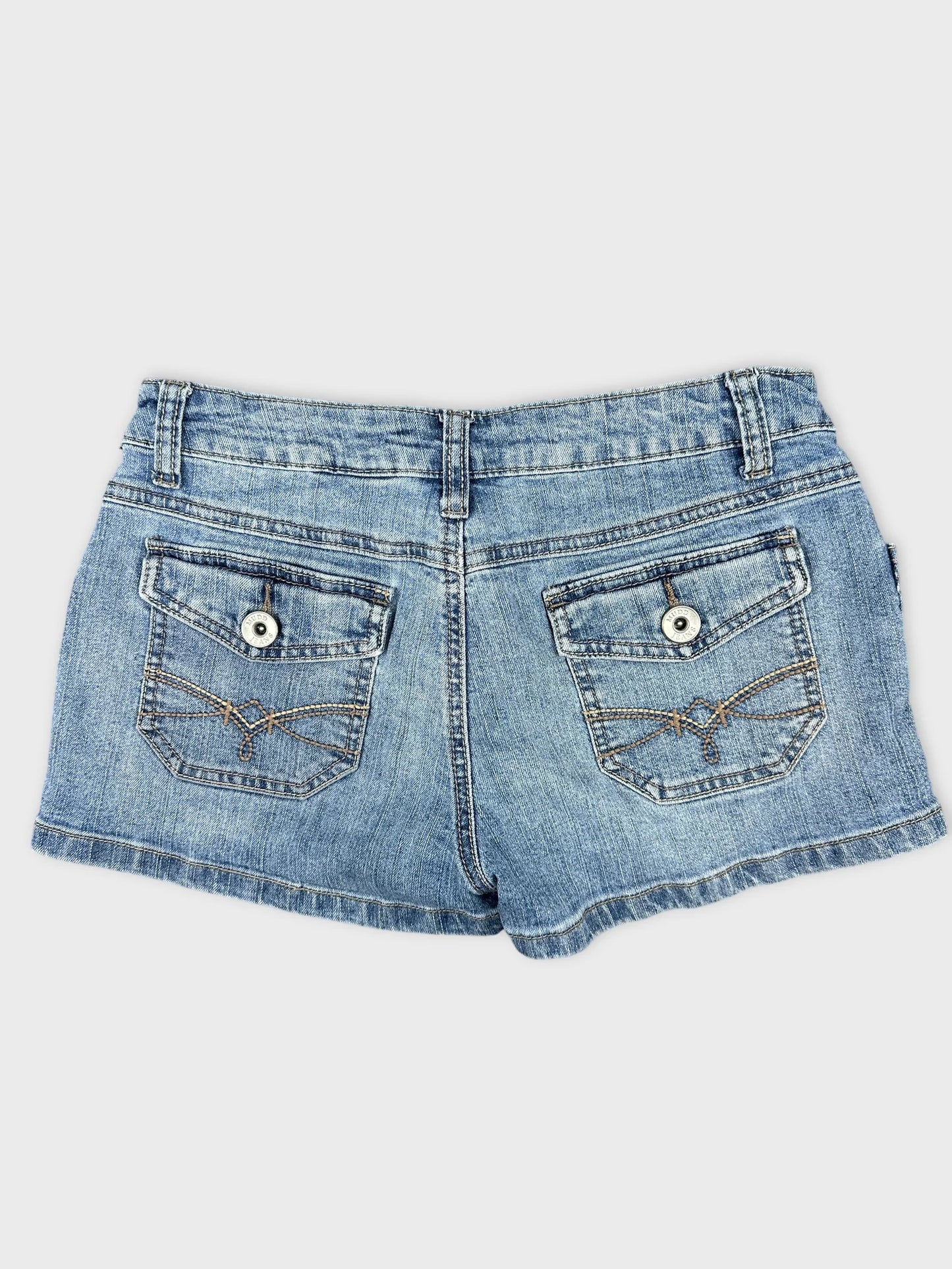 Back view of women denim shorts in faded blue with decorative pocket stitching.