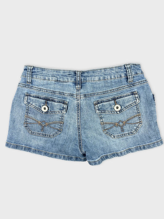 Back view of women denim shorts in faded blue with decorative pocket stitching.