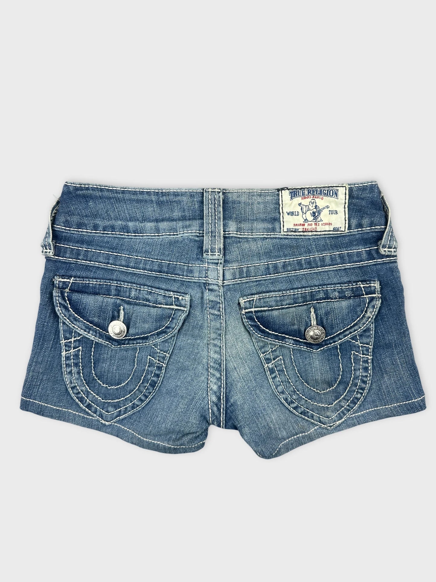 Back view of women denim shorts in light blue with decorative pockets.