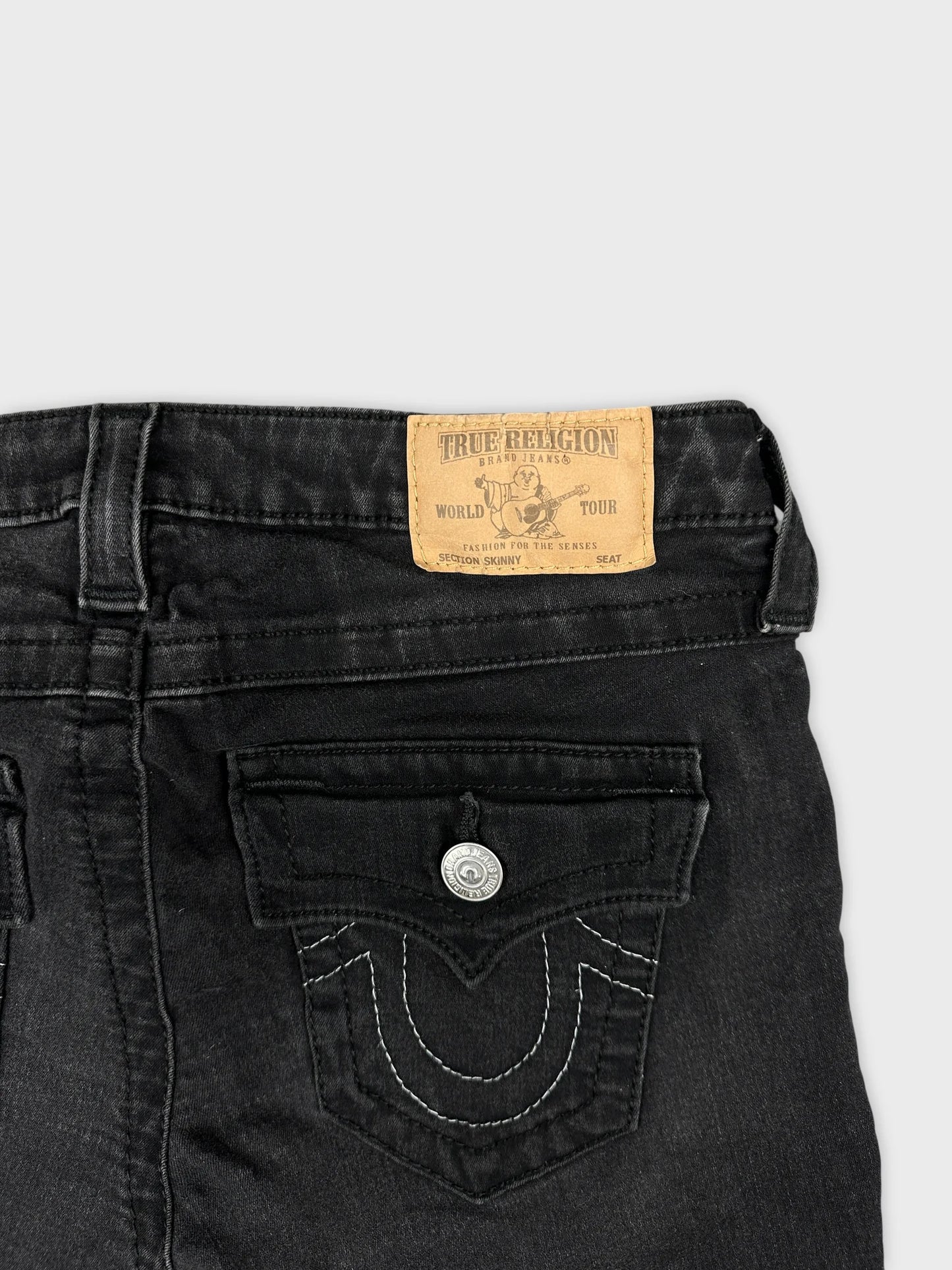 Detail view of women denim shorts in black with decorative stitching